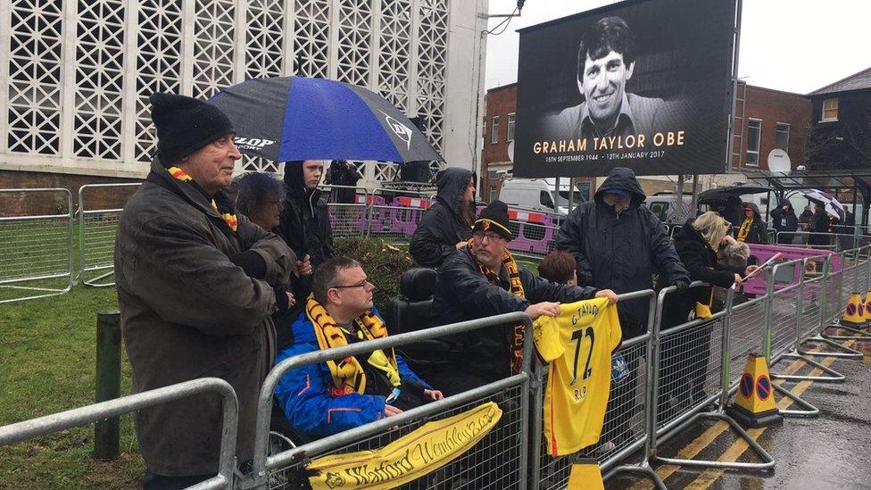 People outside church where funeral is being held