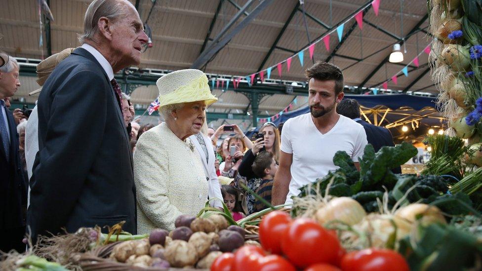 The Royal couple chat to stall holder Simon Matthews during a visit to St George's market in Belfast in June 2014 in Belfast