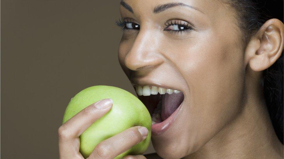 Woman eating an apple