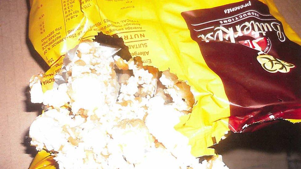 Gnawed packaging of a Butterkist popcorn bag