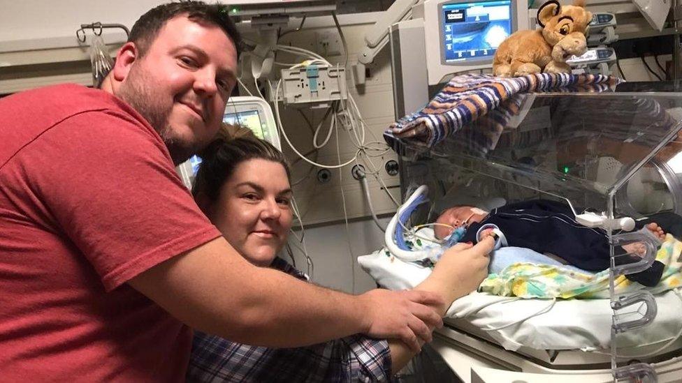 Leiha Shaw with partner Andrew holding baby Orson's hand at the maternity unit