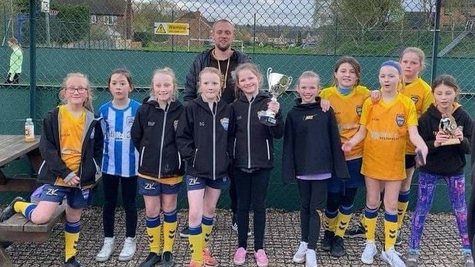 Girls team holding the cup