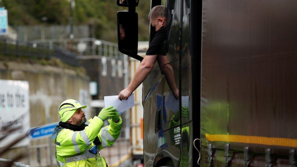 A lorry driver has a document checked