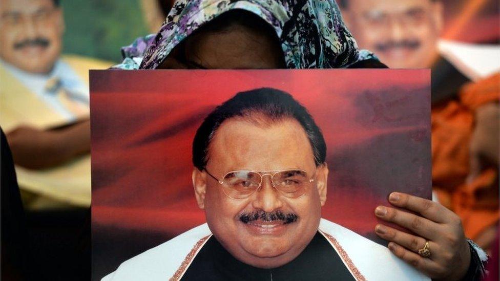 Supporters of Pakistan"s Muttahida Qaumi Movement (MQM) party hold photographs of party leader Altaf Hussain as they stage a sit-in calling for his release in Karachi on June 3, 2014.