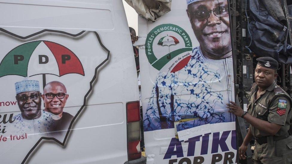 A soldier stood next to a PDP campaign van