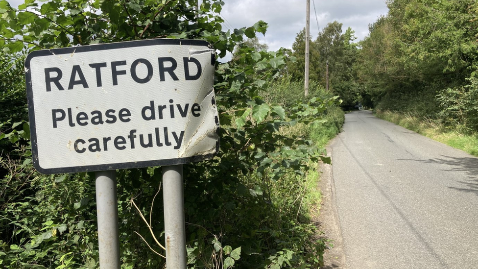 A sign saying Ratford on a rural road