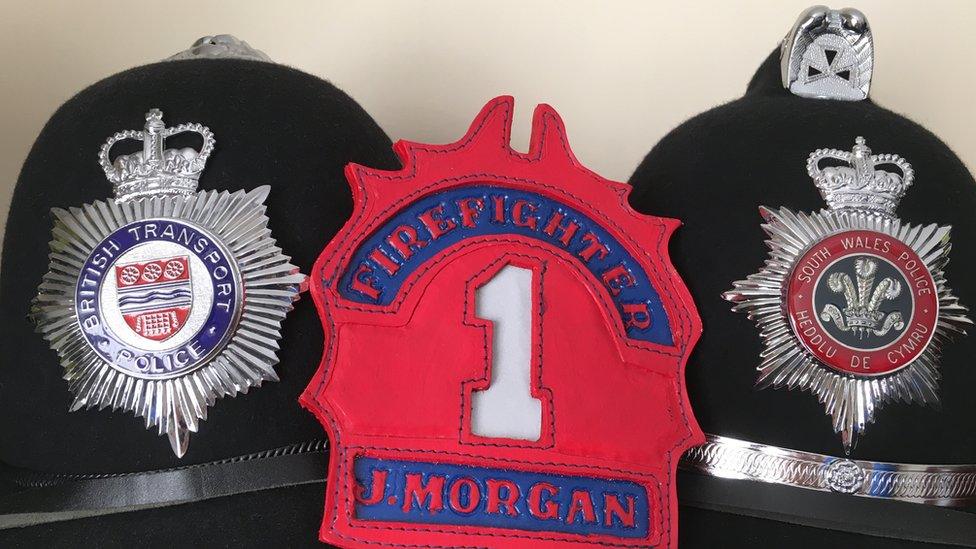 Two police helmets and a police badge