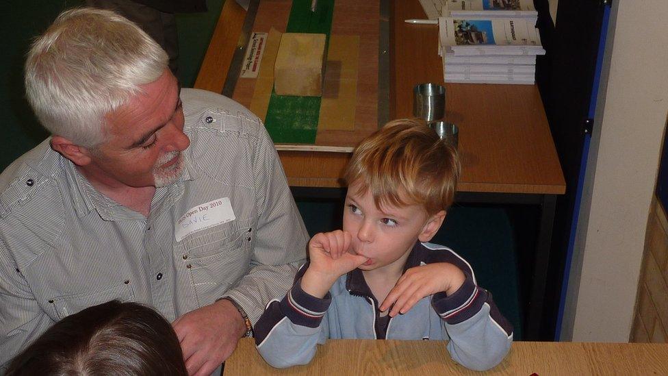 David Galloway explains earthquakes to a child at the BGS open day.