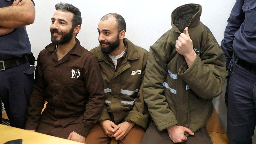 French national Romain Franck (R), 24, a worker at the French consulate, and Palestinian Moufak al-Ajluni (L) and Mohamed Katout (C) appear in court in the Israeli city of Haifa on 19 March 2018