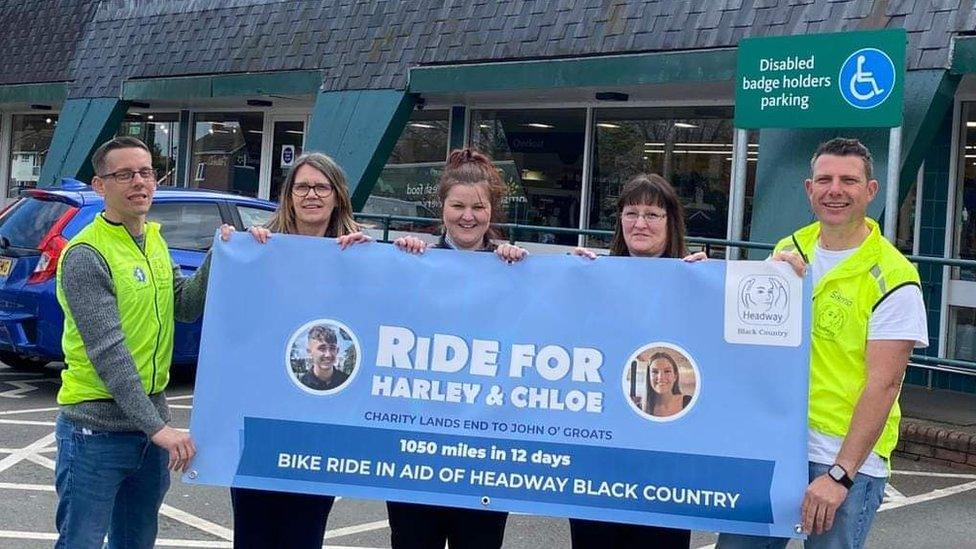 Fundraisers holding a Ride for Harley & Chloe sign