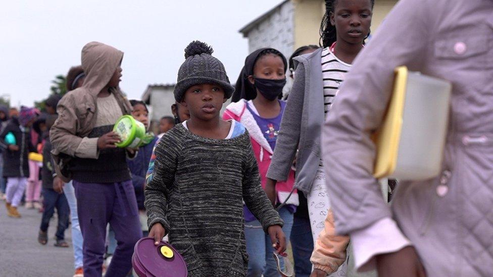 Crowd queuing at feeding scheme place in Cape Town