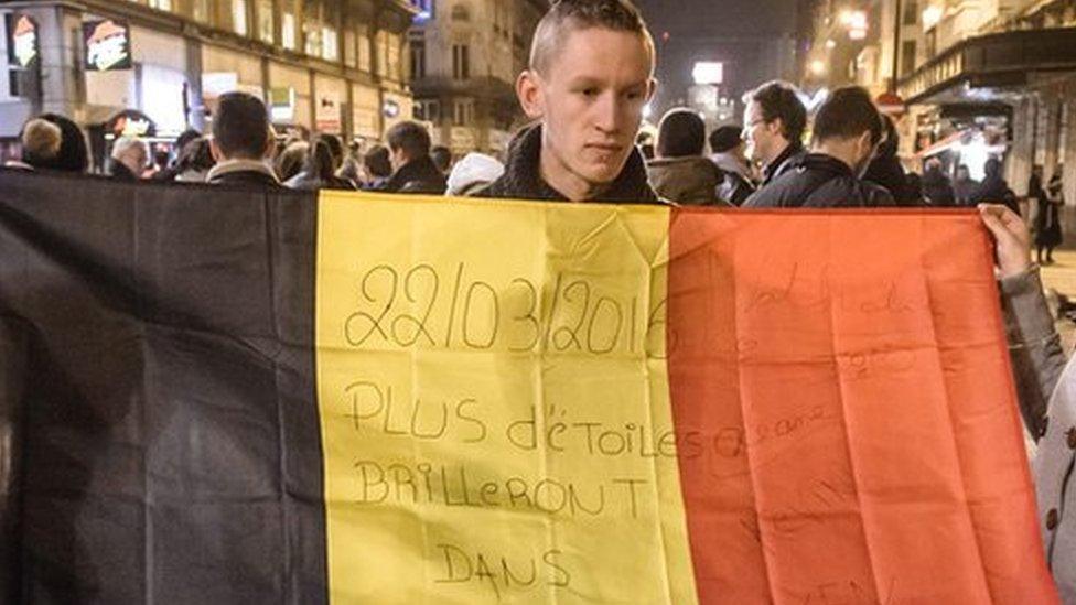 People gather and light candles at the Place de la Bourse during a vigil to pay tribute to the victims of the attacks in Brussels, Belgium. 22 March 2016