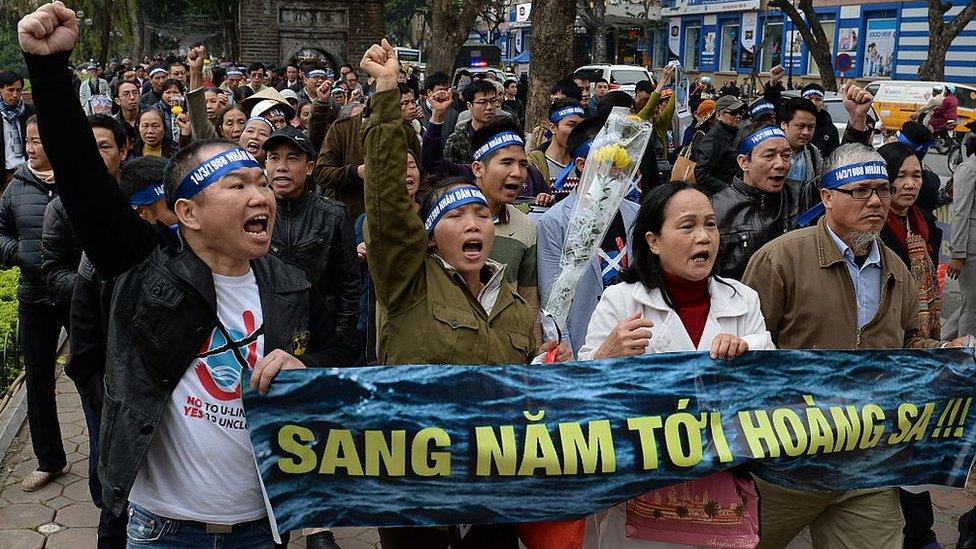 Activists chant anti-China slogans during a rally in Hanoi on March 14, 2016, to mark the anniversary of a 1988 battle in the Spratly Islands, a rare act of protest over an issue that has come to dog relations between Hanoi and Beijing.