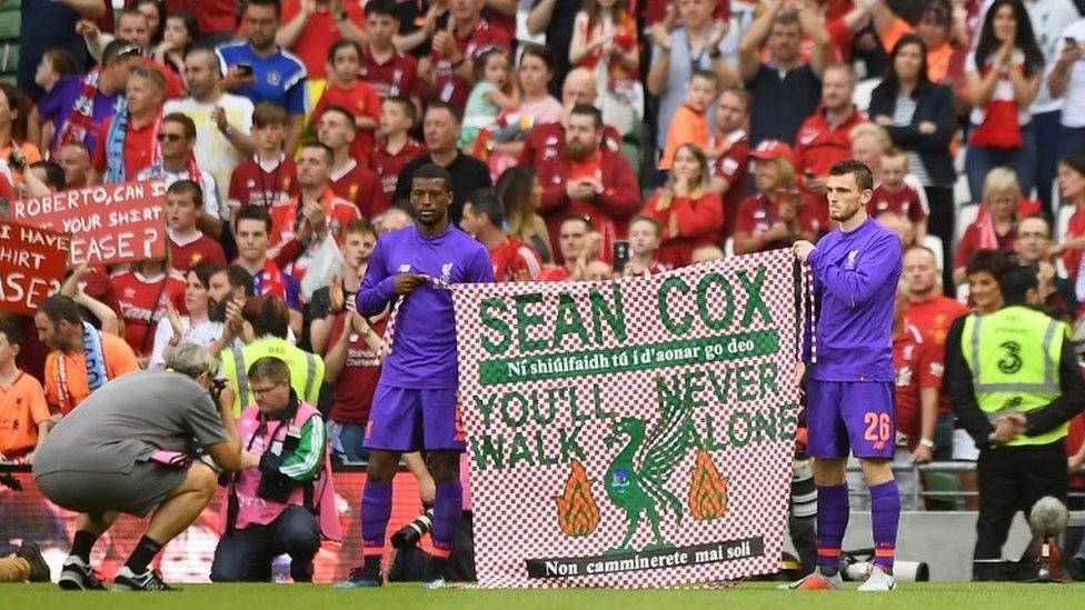 Liverpool's Georginio Wijnaldum and Andrew Robertson hold up a banner in support of Liverpool fan Sean Cox