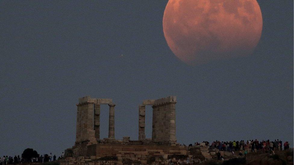 The moon above the Temple of Poseidon in Cape Sounion, east of Athens, Greece.