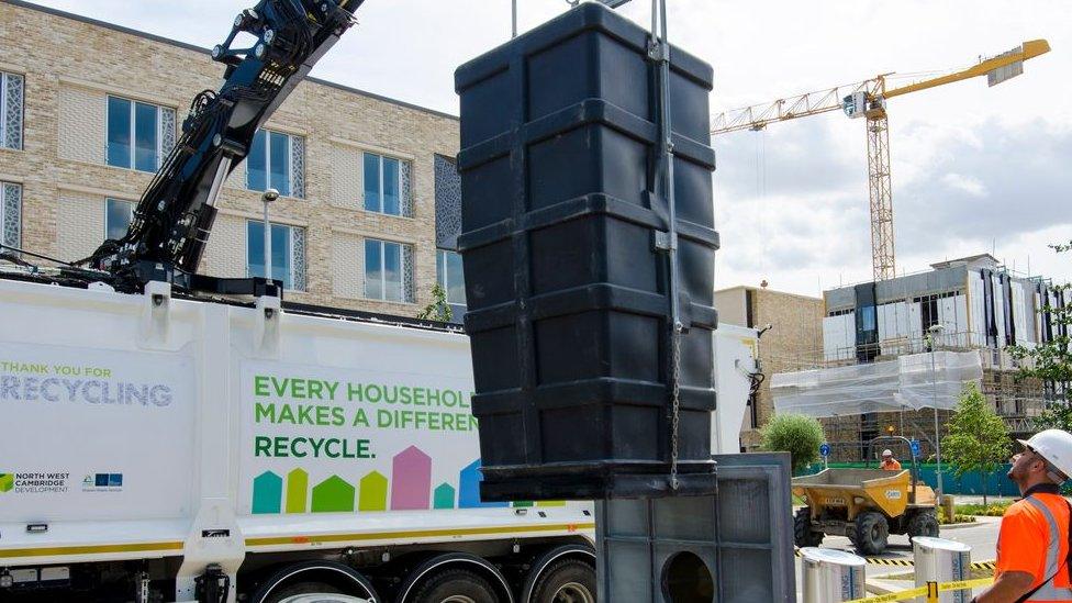 Underground bins lifted by a crane