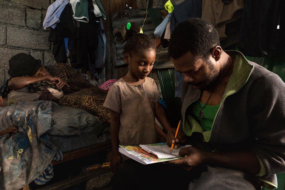 Jean Michelle with his seven-year-old daughter Fatdjoulie