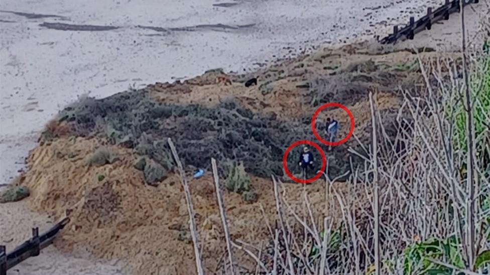 Two people on collapsed cliff