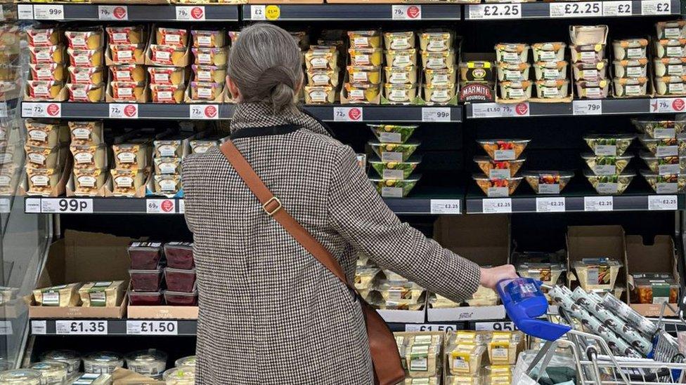 Woman looking at supermarket shelves