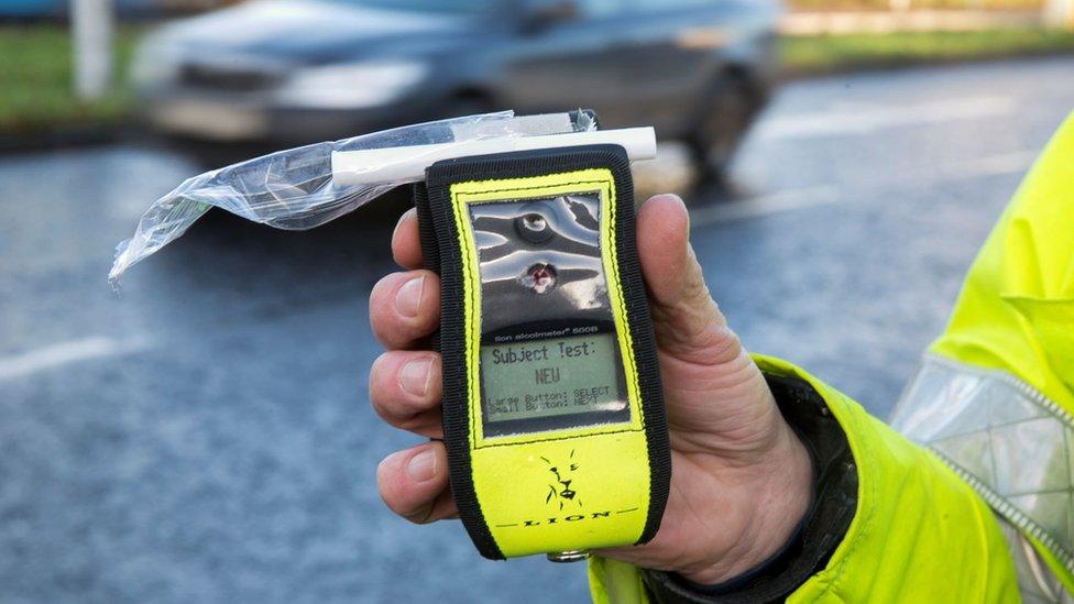 Policeman holding a breathalyser kit