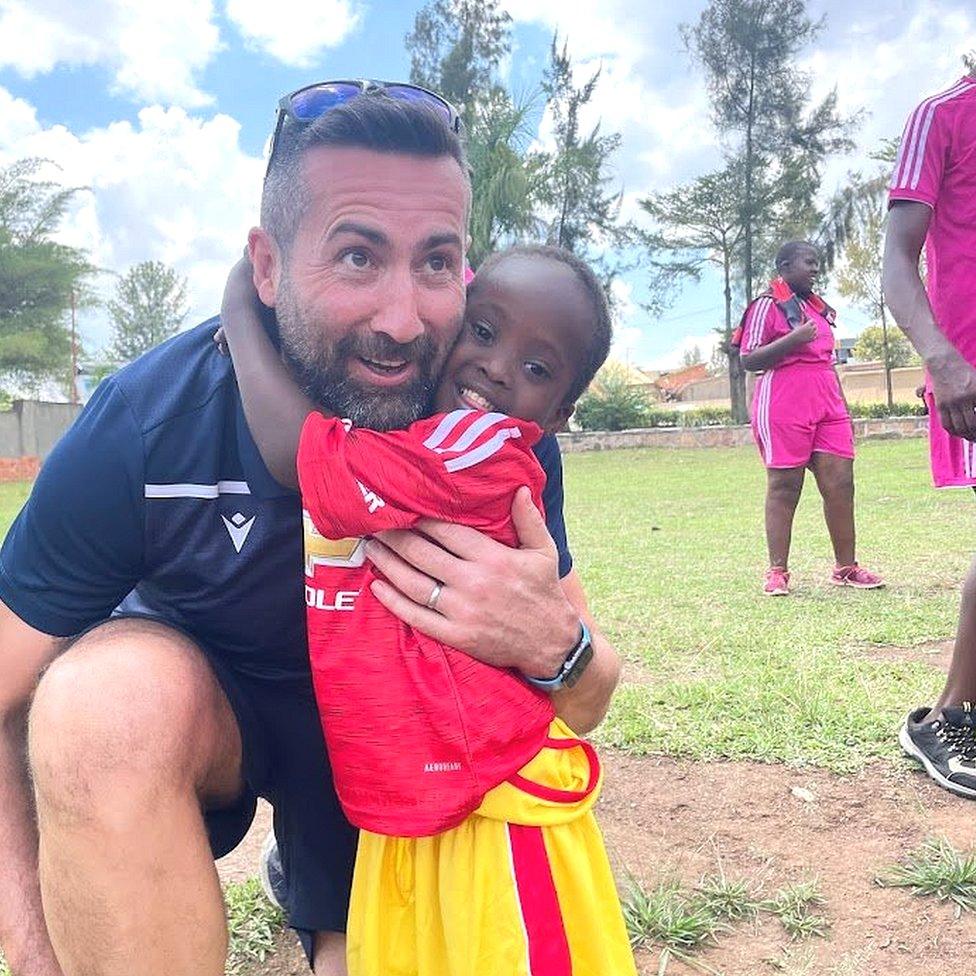 One youngster hugs his coach