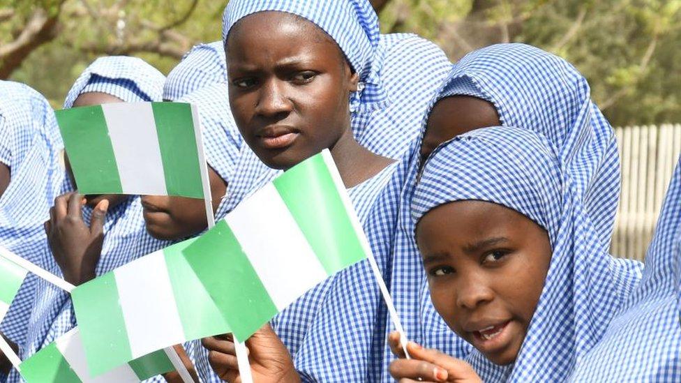 schoolgirls waving flags