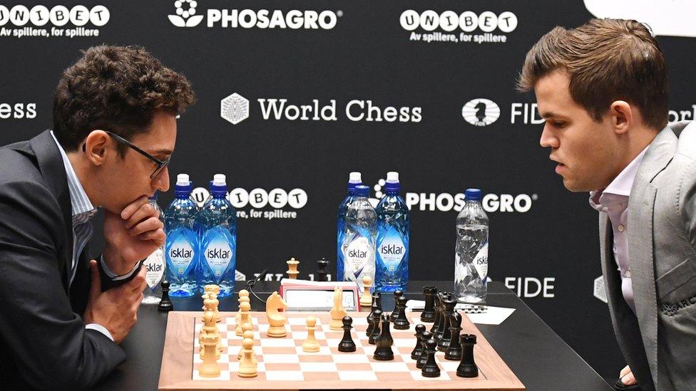 Norway's World Chess Champion Magnus Carlsen (R) plays against US challenger Fabiano Caruana (L) at the Round Ten game during the World Chess Championship 2018 in London, Britain, 22 November 2018.