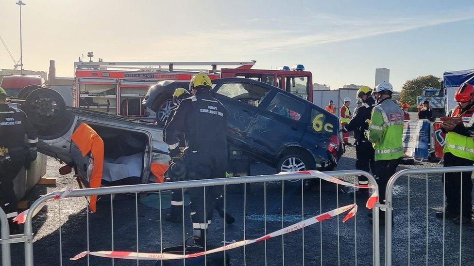 Car being cut open by firefighters