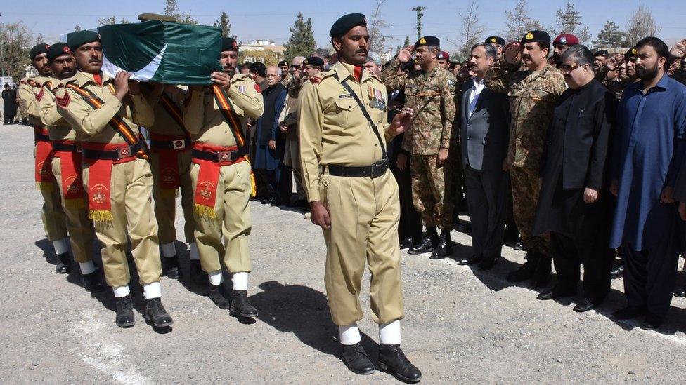 Photo taken on 25 October 2016 showing military men carrying a coffin at a funeral for police cadets killed in Quetta, attended by Balochistan province Chief Minister Nawab Sanaullah Zehri (second right), Pakistan Army Chief General Raheel Sharif (third right) and Directorate General for Inter-Services Intelligence Lieutenant-General Rizwan Akhtar (fourth right), among others.