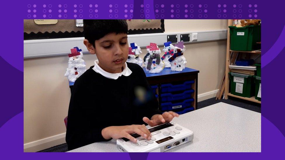 Ayaan-using-braille-sense-machine