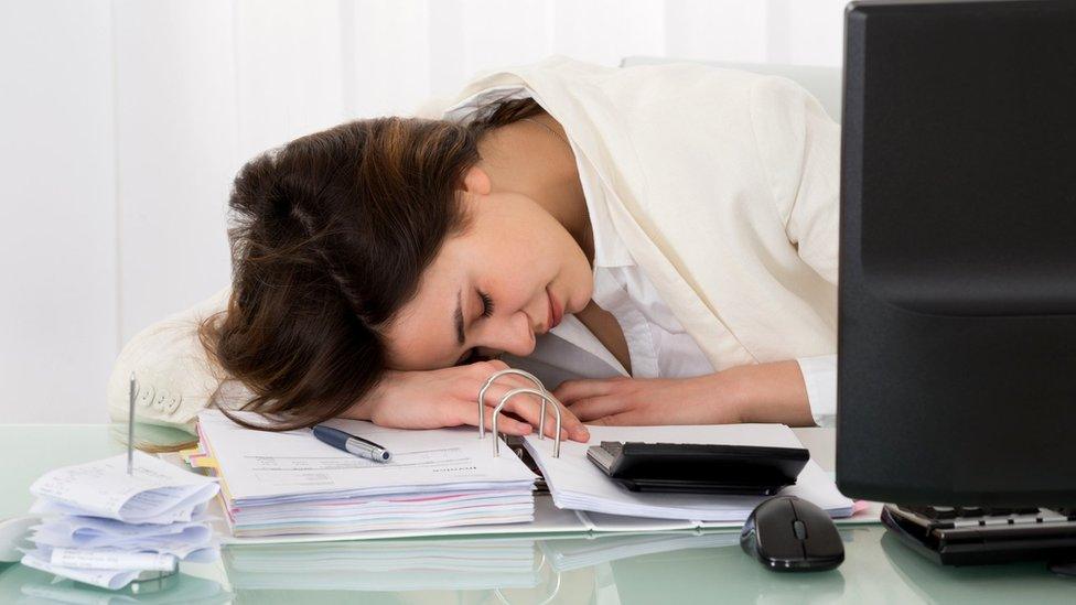 Businesswoman sleeping on desk