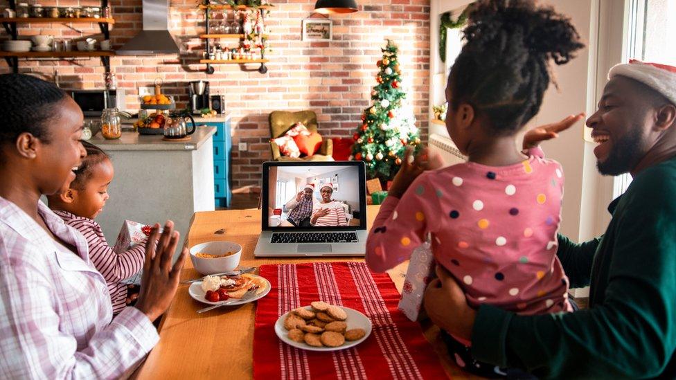 Stock photo of a family using zoom at christmas