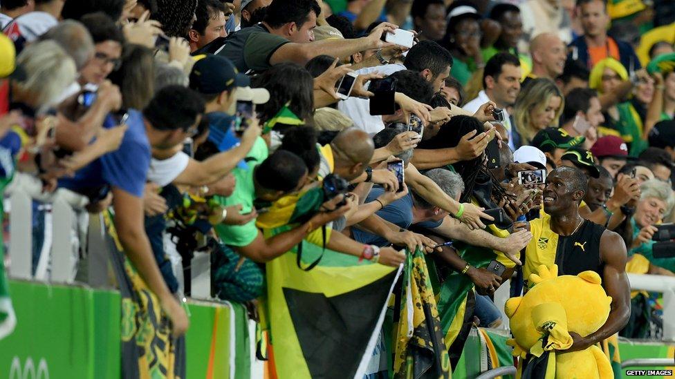 Usain Bolt celebrates with fans