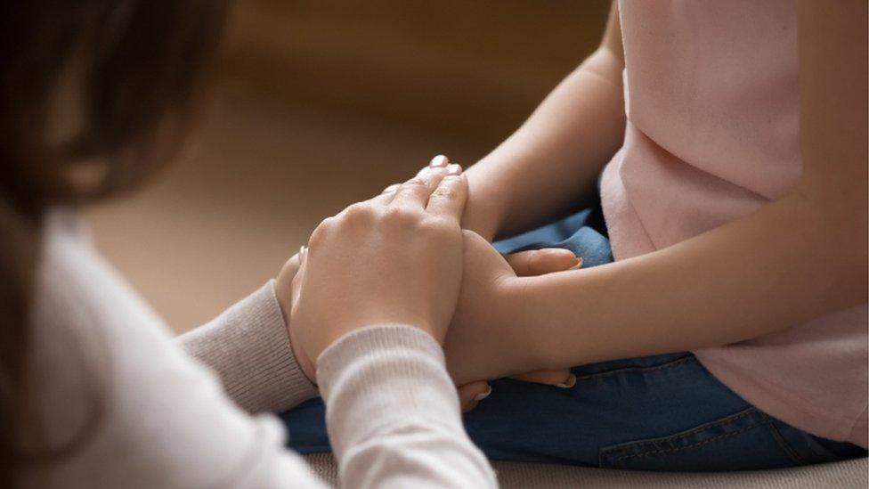 Generic image of woman holding child's hand