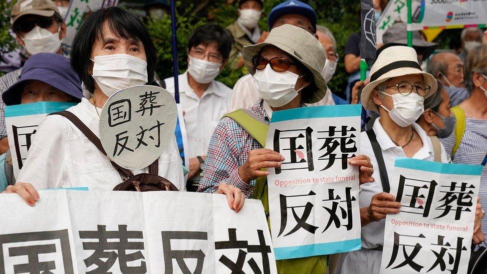 Protesters hold placards reading 'No!! State funeral' during a rally against the state funeral of former Prime Minister Shinzo Abe in Tokyo, Japan, 27 September 2022.