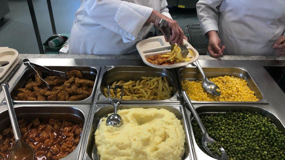 servers putting food on trays