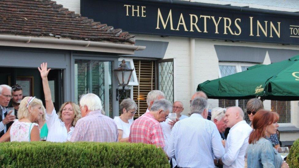 Villagers outside the Martyrs Inn