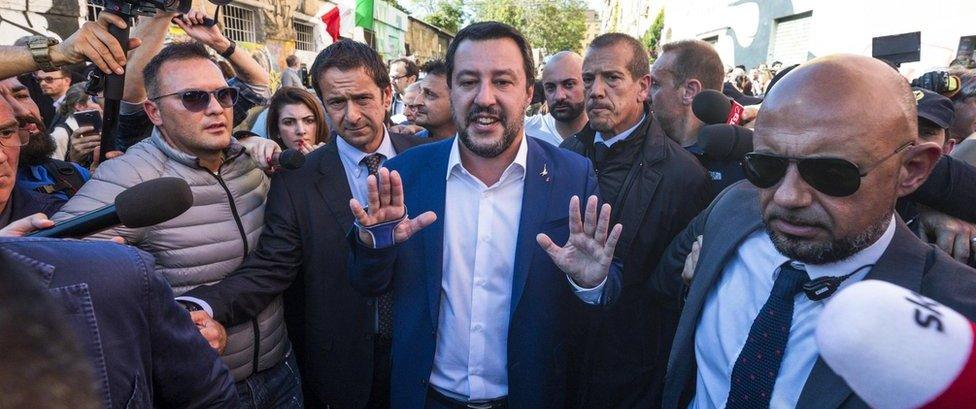 Interior Minister and Deputy Premier Matteo Salvini (C) reacts as he visited the abandoned building in the San Lorenzo district of Rome