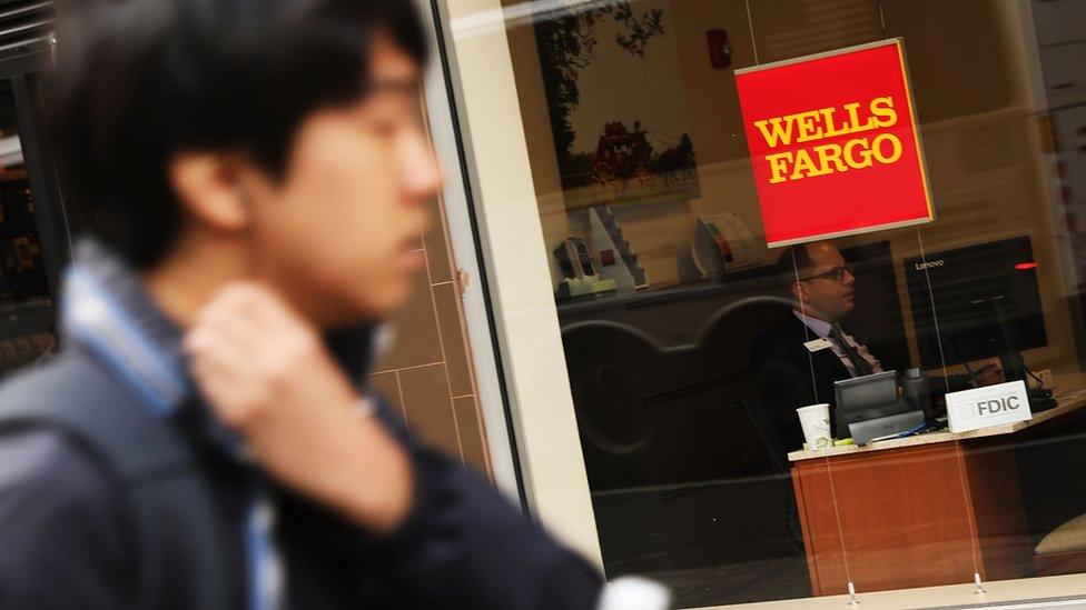 People walk by a Wells Fargo bank branch on October 13, 2017 in New York City.