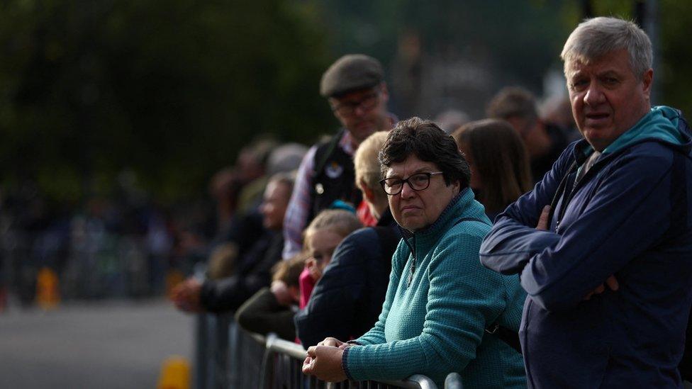 People line the street waiting for the funeral cortage carrying Britain's Queen Elizabeth in the village of Ballater