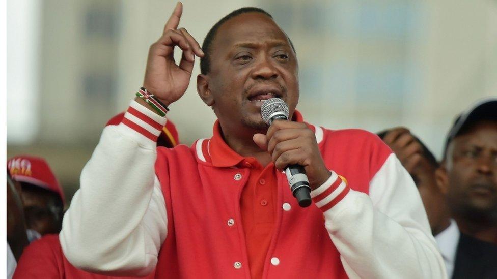 Kenya"s President Uhuru Kenyatta (L) of the Jubilee Party addresses his supporters on May 29, 2017 after receiving the clearance certificate of the Independent Electoral and Boundaries Commission (IEBC) following the presentation of his candidacy for the presidential race in Nairobi