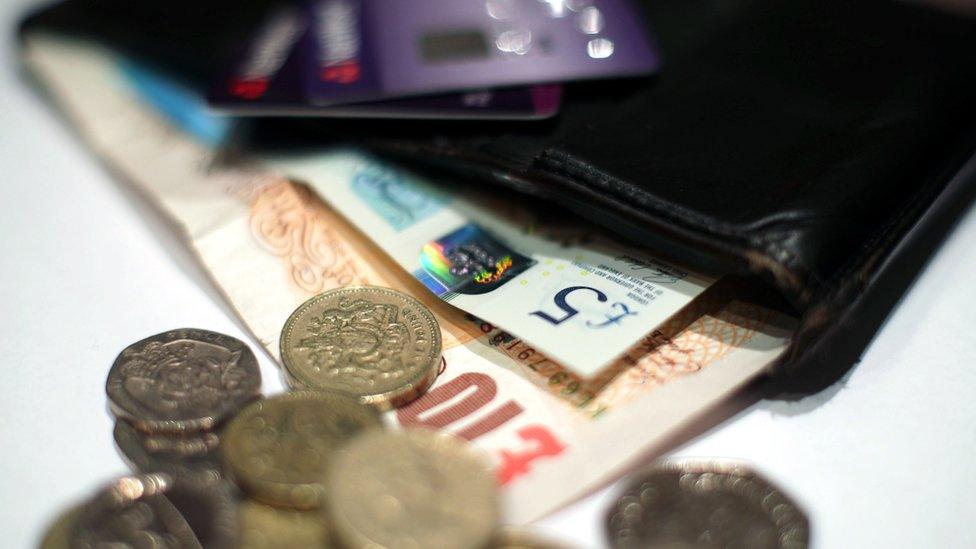 Coins and a five pound and ten pound banknote, along with Natwest bank cards in a wallet