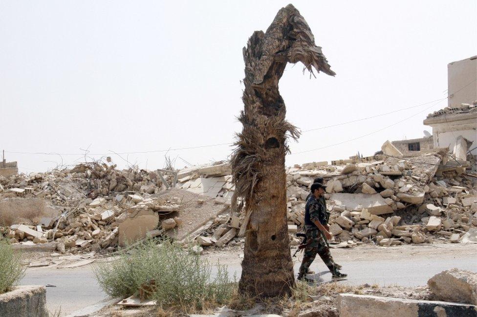 Syrian soldiers patrol Darayya, near the capital Damascus