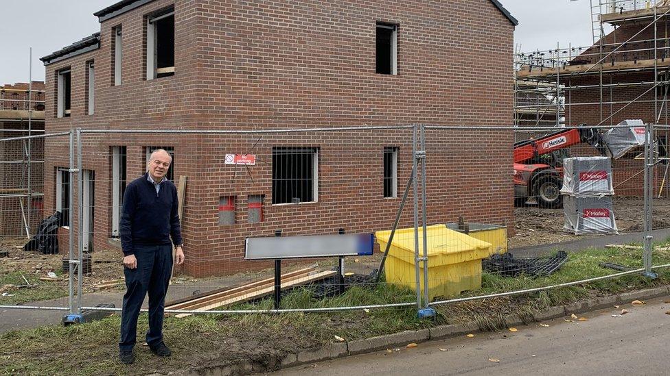 Clive Betts standing by a new build house