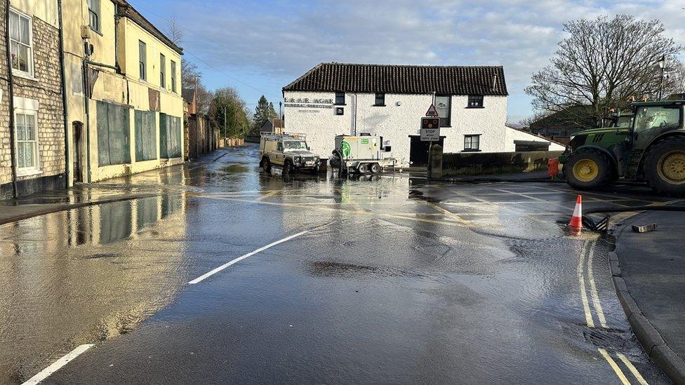 Water covering sinkhole in road in Malton