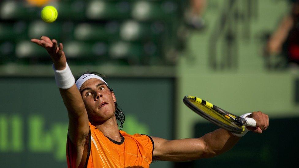 Closeup of Rafael Nadal in action, making serve during match at Crandon Park, Key Biscayne in April 2005