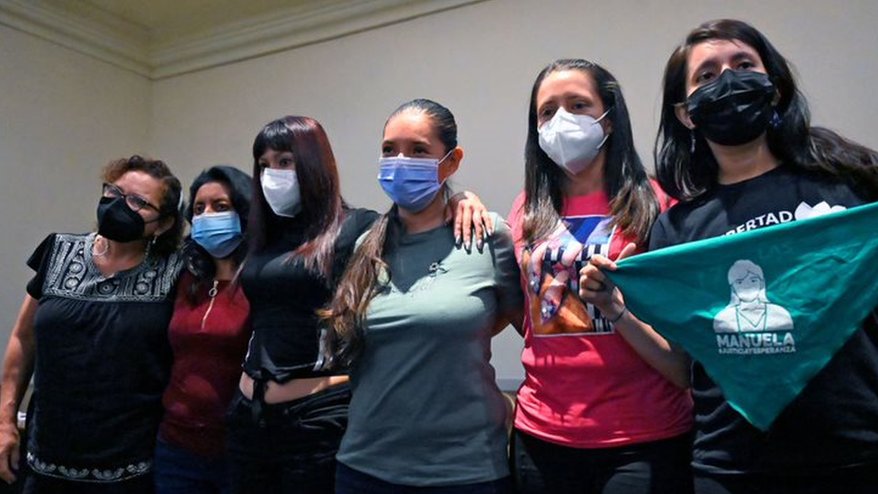 Karen (second from right) poses for pictures during a press conference following her release