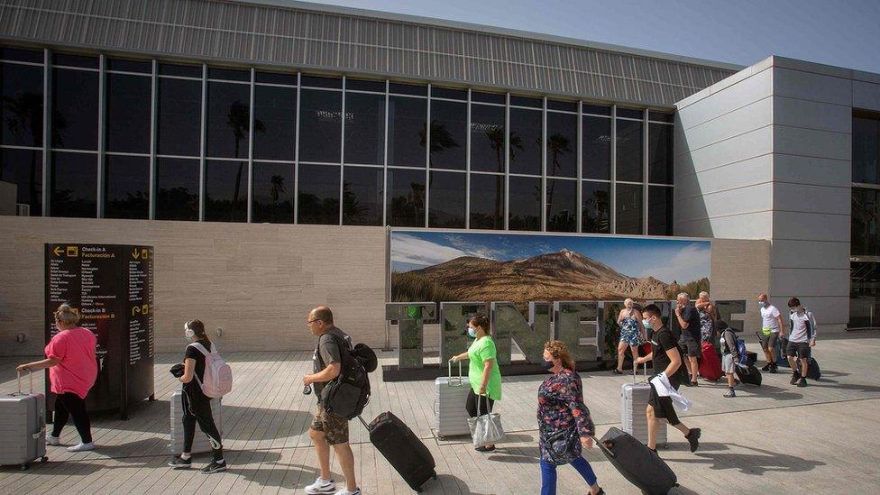 British tourists arrive at the Tenerife Sur Reina Sofia airport on the Canary Island of Tenerife on Tuesday