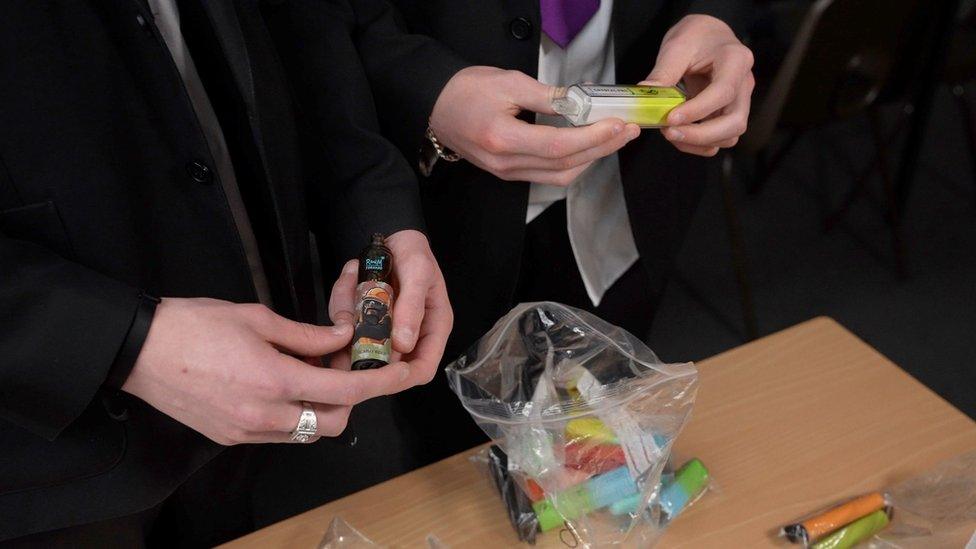 School pupil holding vapes