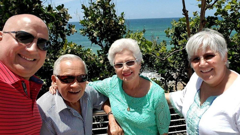 Juan Molina (L), who requires cancer treatment in Puerto Rico, with his wife Teresa (R) and parents.